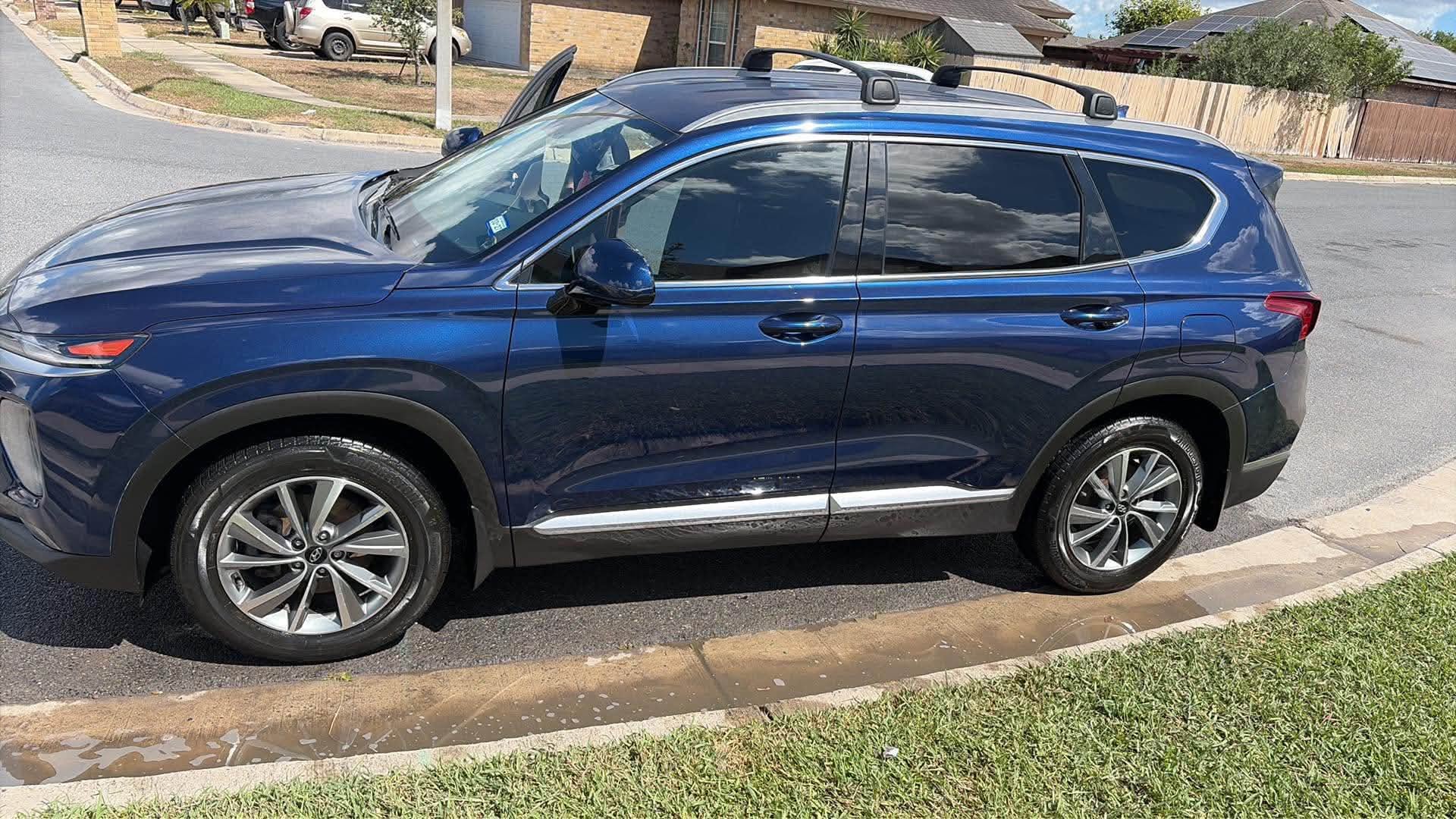 Blue Hyundai Santa Fe clean at the kerb